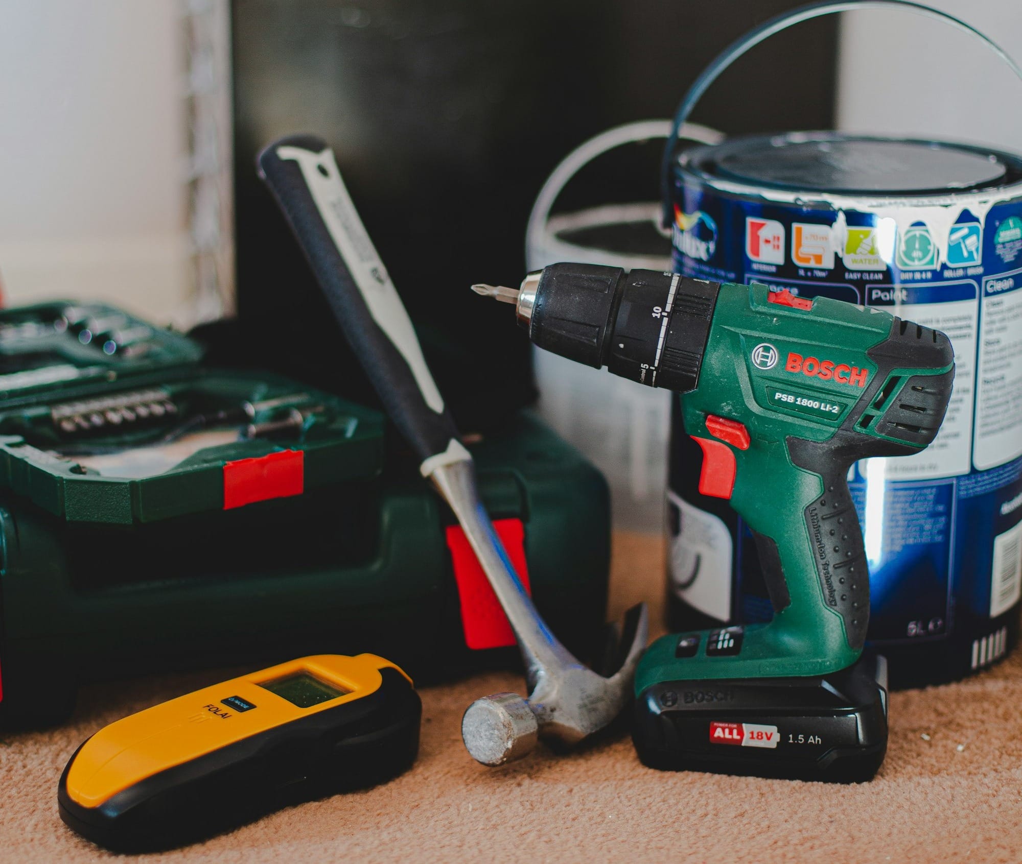 red and black cordless power drill beside black and red cordless power drill